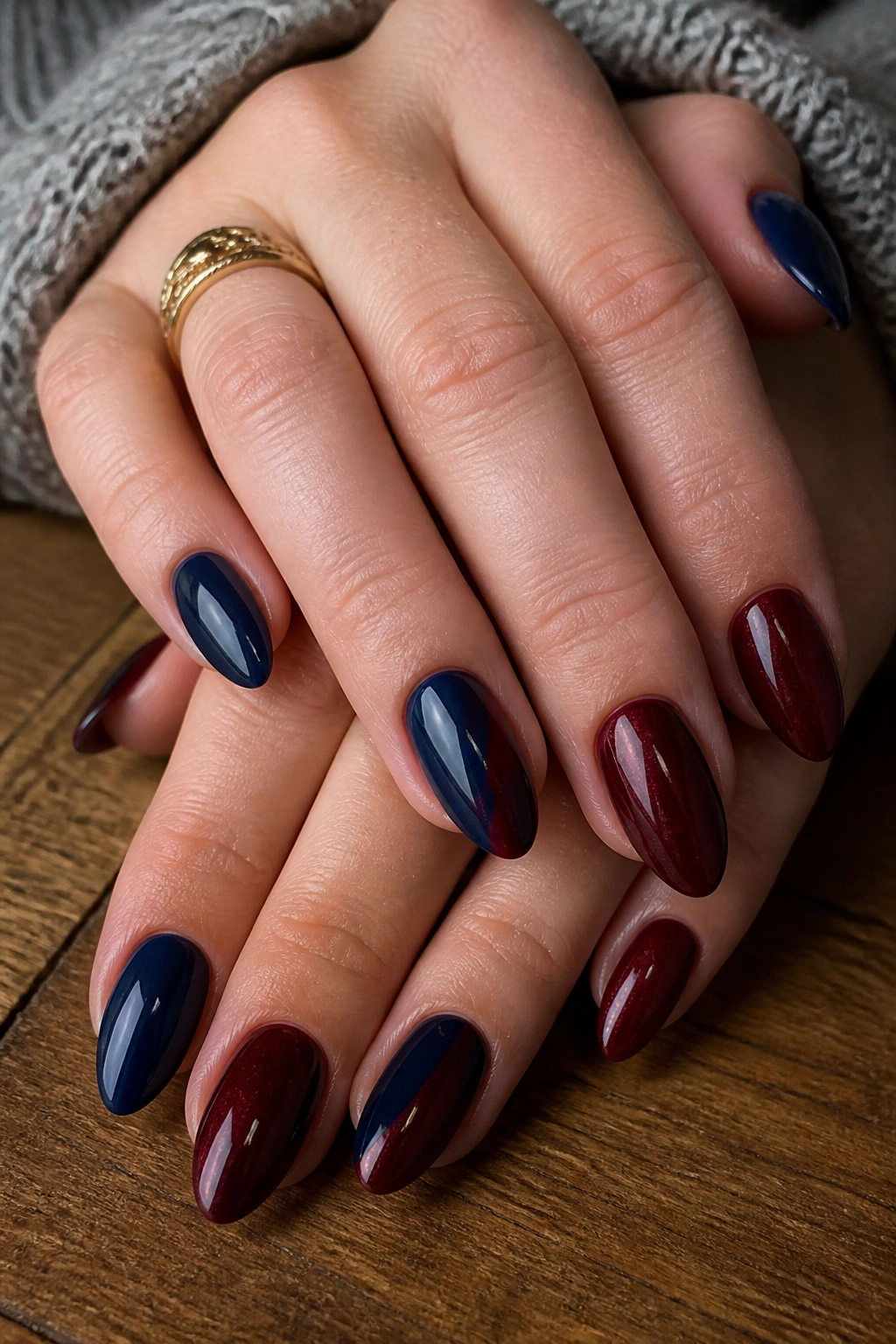 Almond nails in navy and burgundy tones with mixed finishes