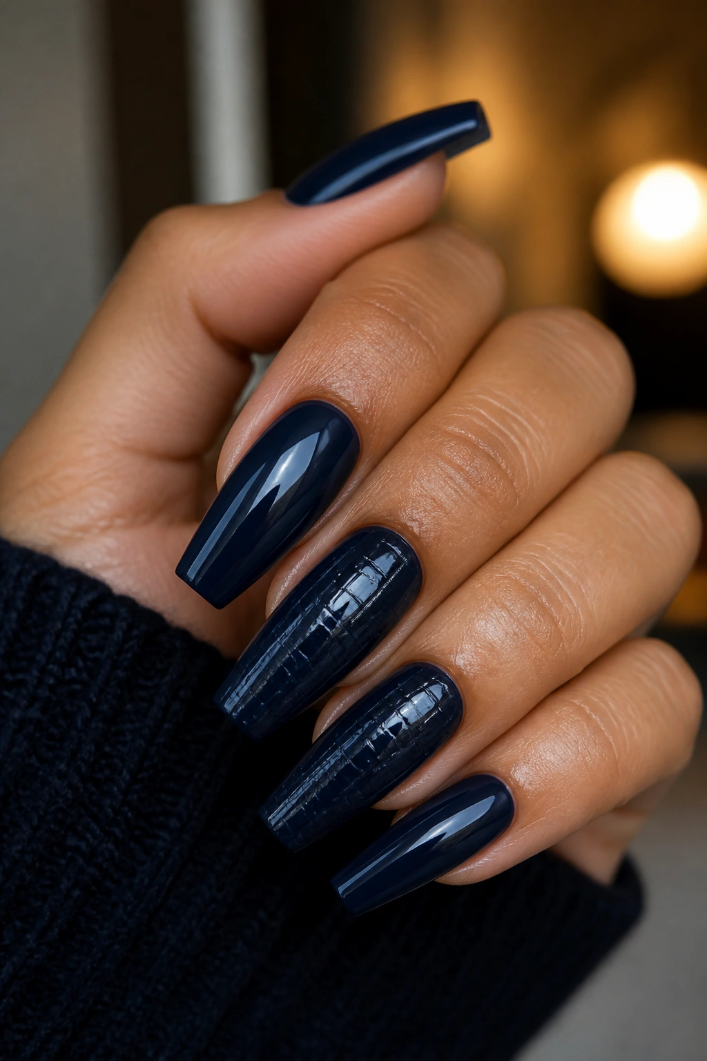 Close-up of navy croc-embossed coffin nails on fingers