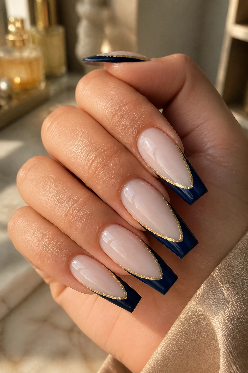 Navy tips with brushed gold border on coffin nails