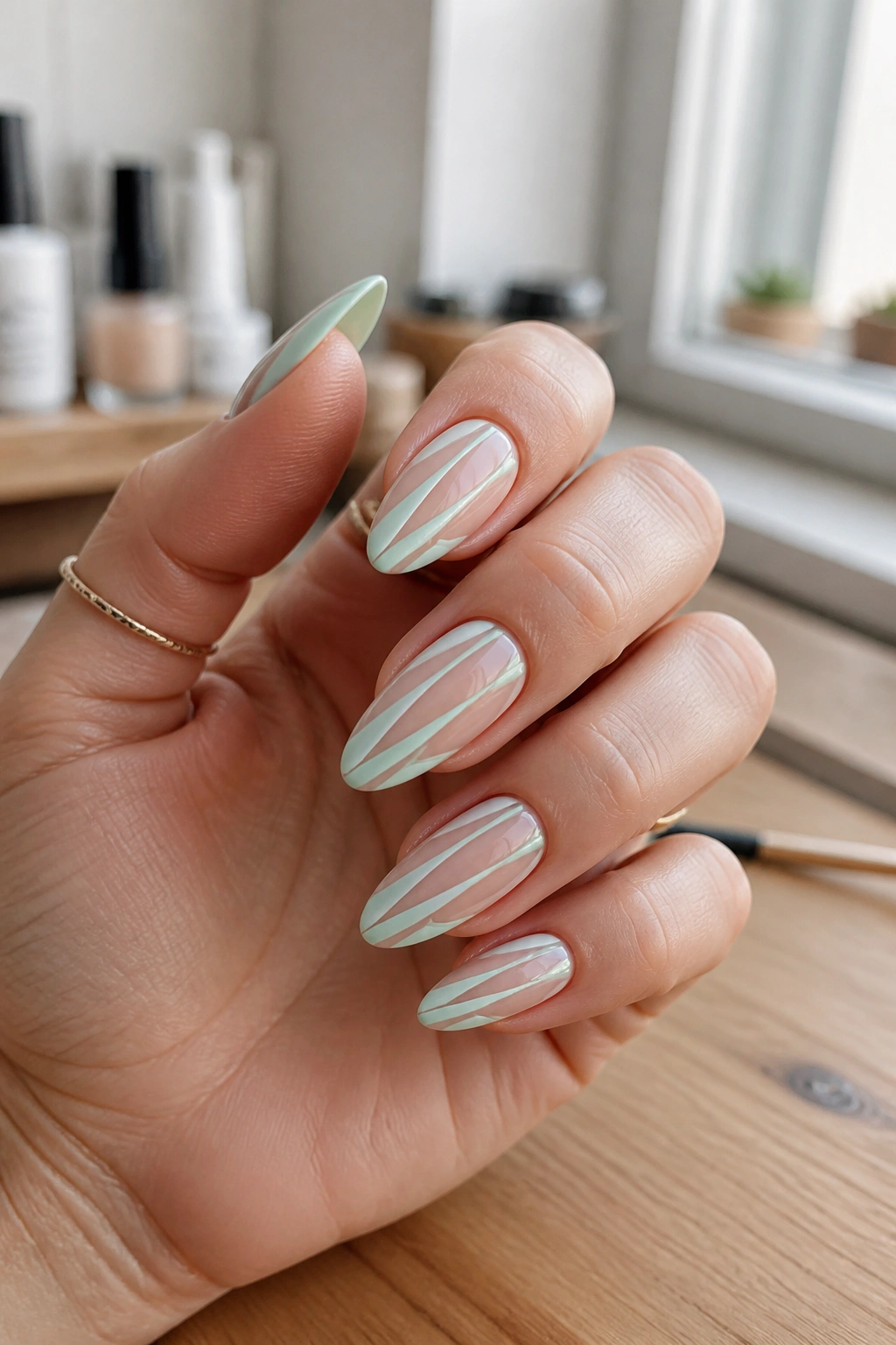 Close-up of negative space mint striping on almond nails