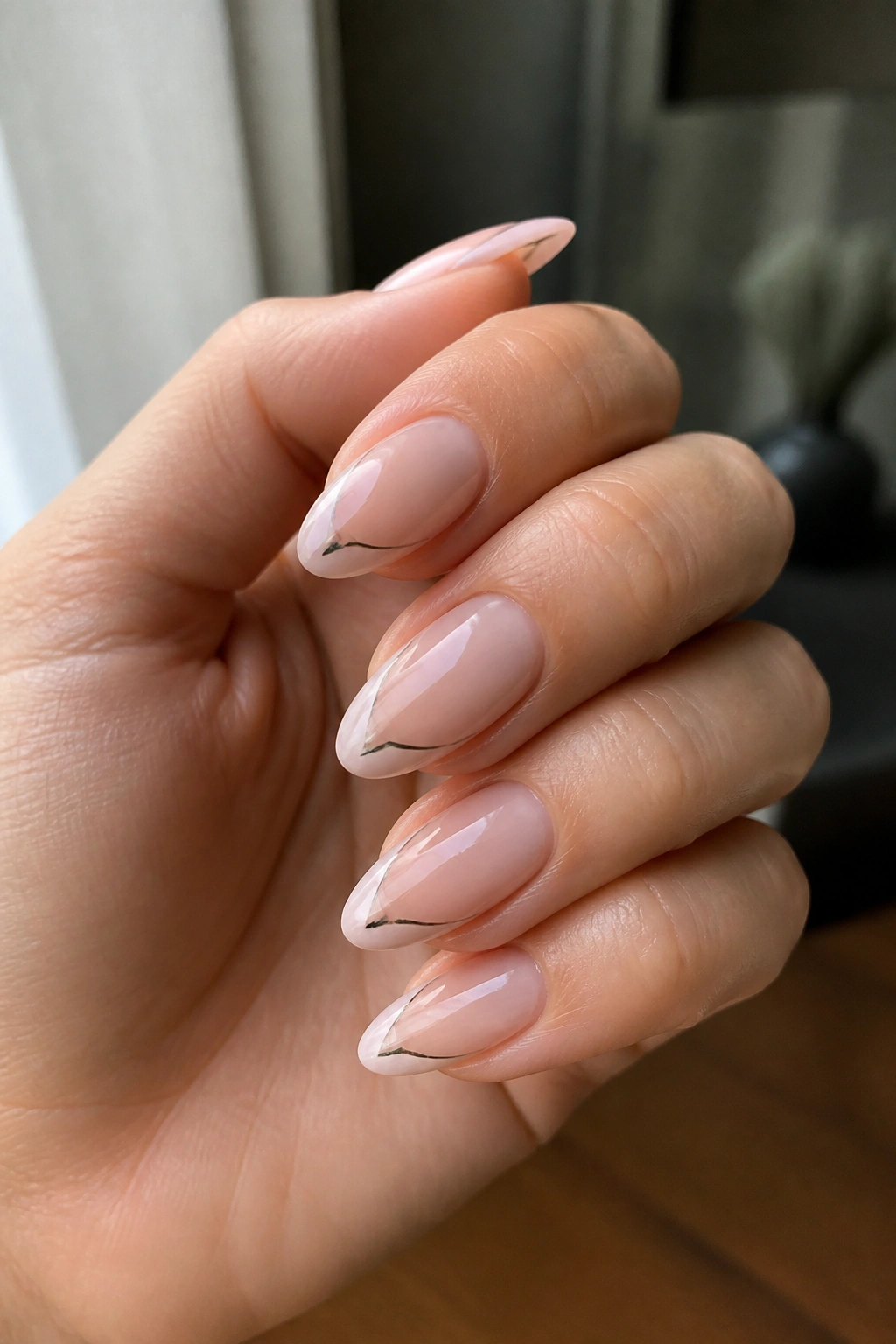 Almond nails showing negative-space side mark on nude base