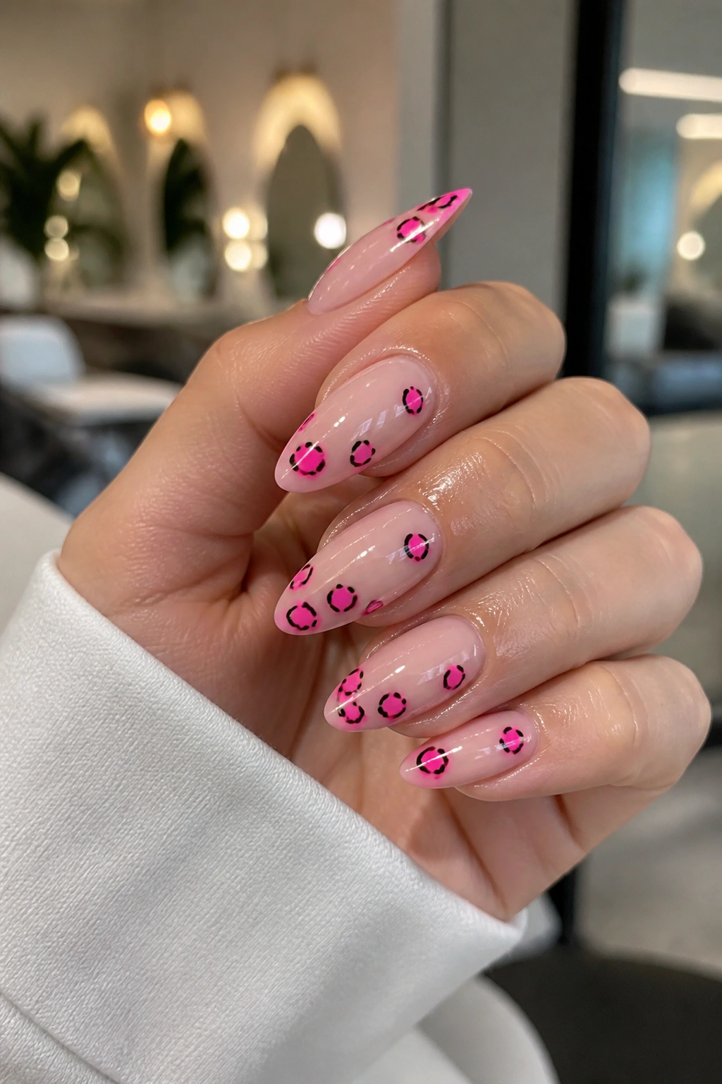 Almond nails with neon cheetah spots on nude base