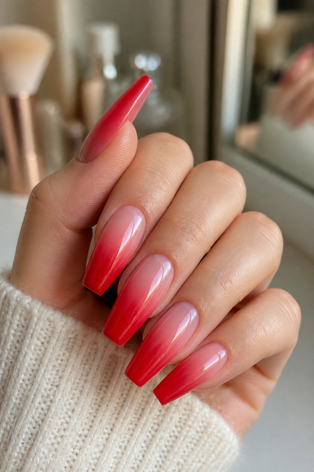 Nails with red to pink ombre fade on coffin shape