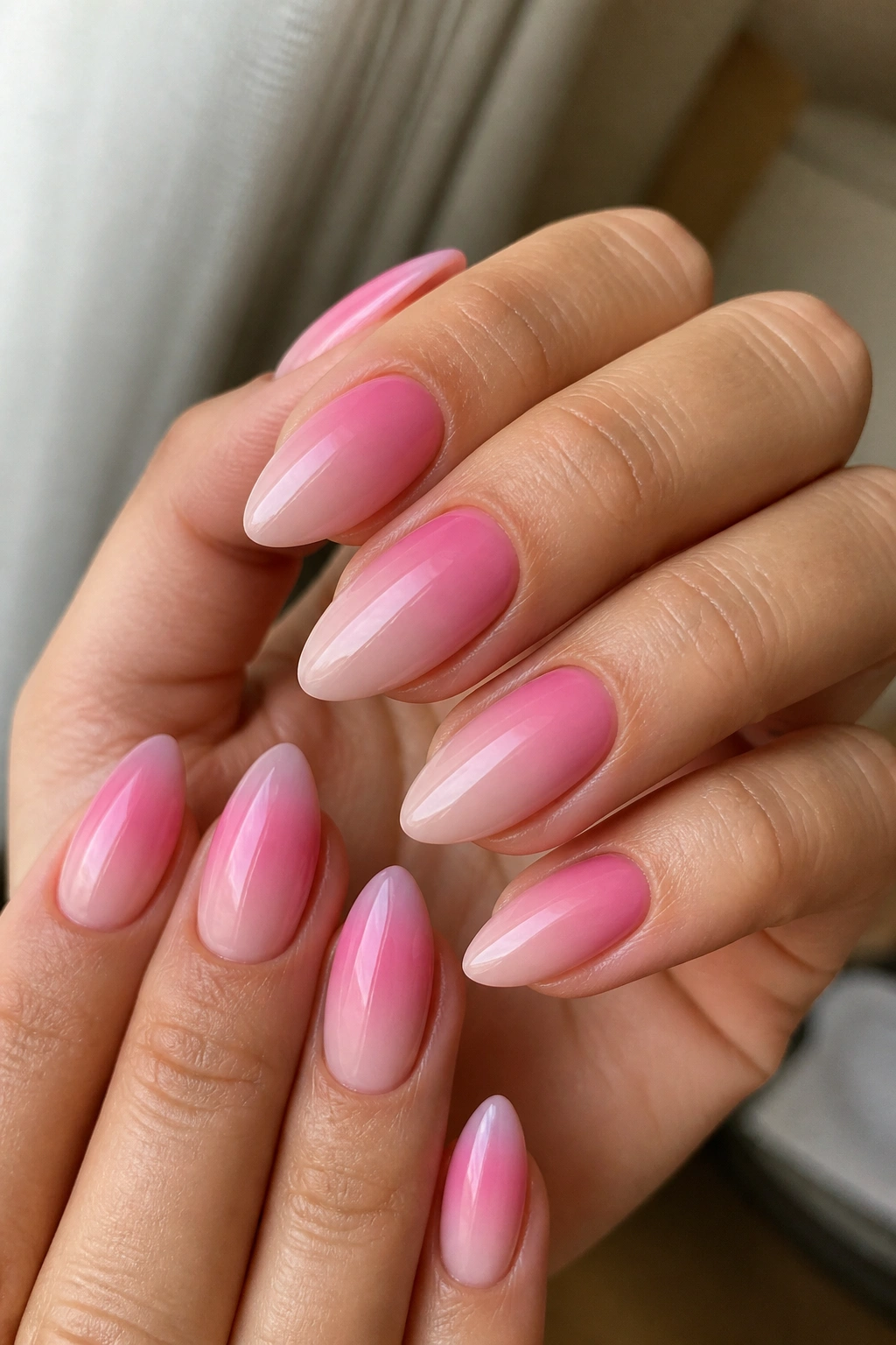 Pink ombré on almond nails fading into milky nude