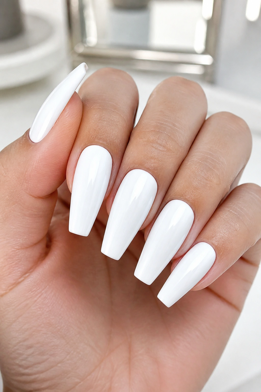 Close-up of hands with crisp opaque gel white coffin nails