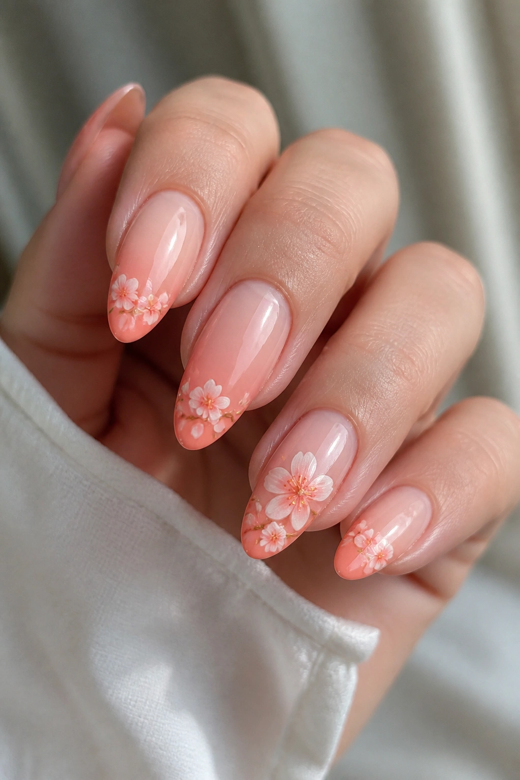 Almond nail with peach gradient and blossom tips