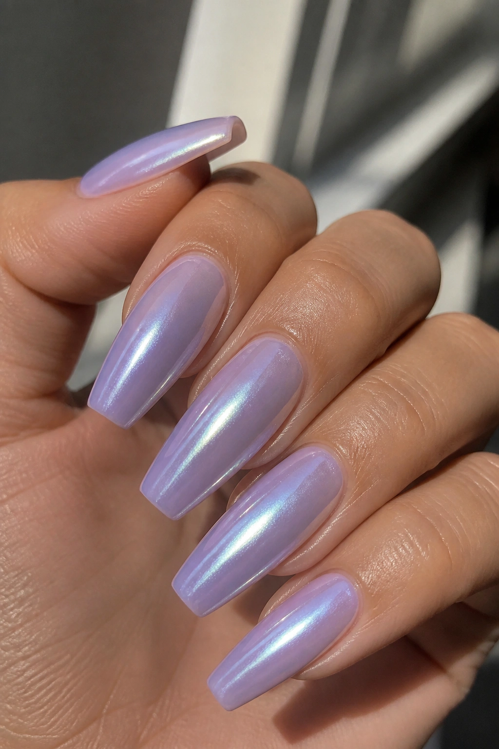 Close-up of pearl-glazed lavender coffin nails with nacre sheen