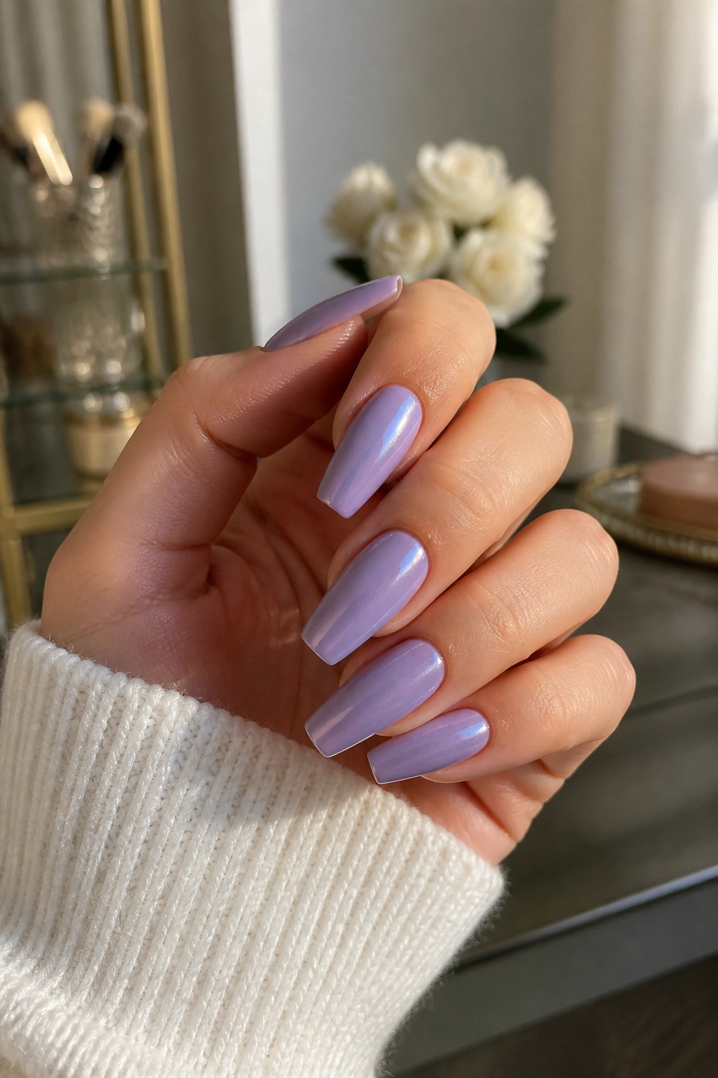 Close-up of real hand with periwinkle coffin nails and pearl chrome veil