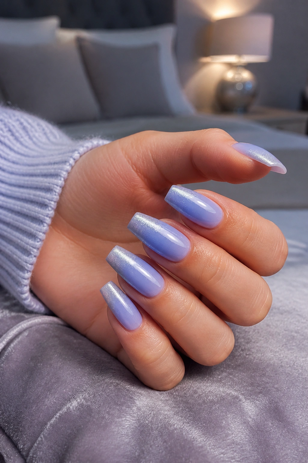 Close-up of periwinkle-to-silver chrome ombre nails on real hand