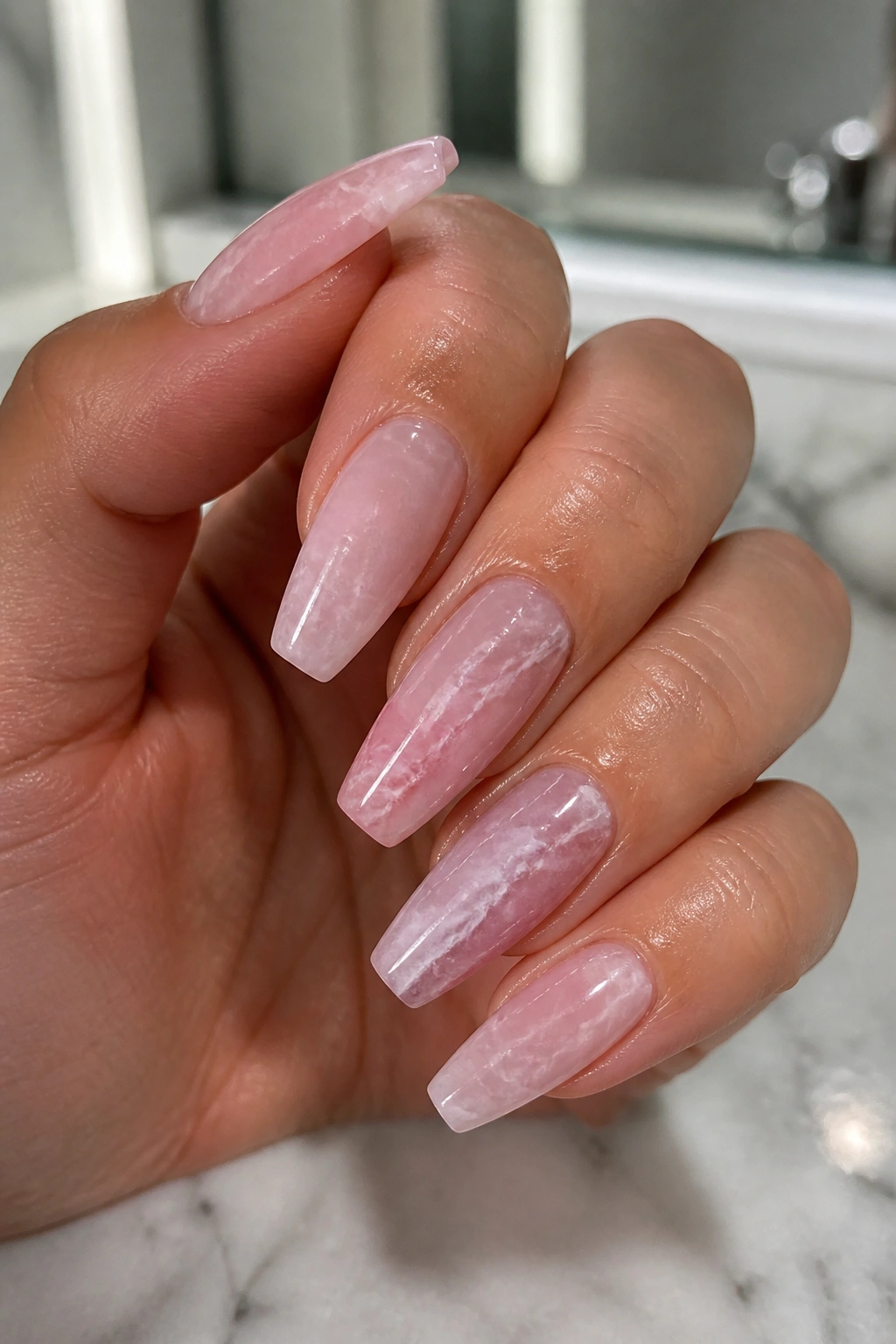 Close-up of pink quartz marble coffin nails with white veins