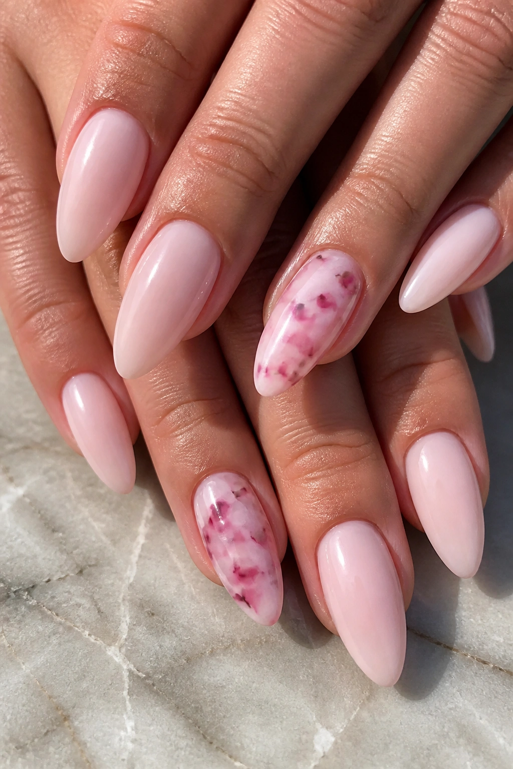 Close-up of pink tortoiseshell accent nails on milky base