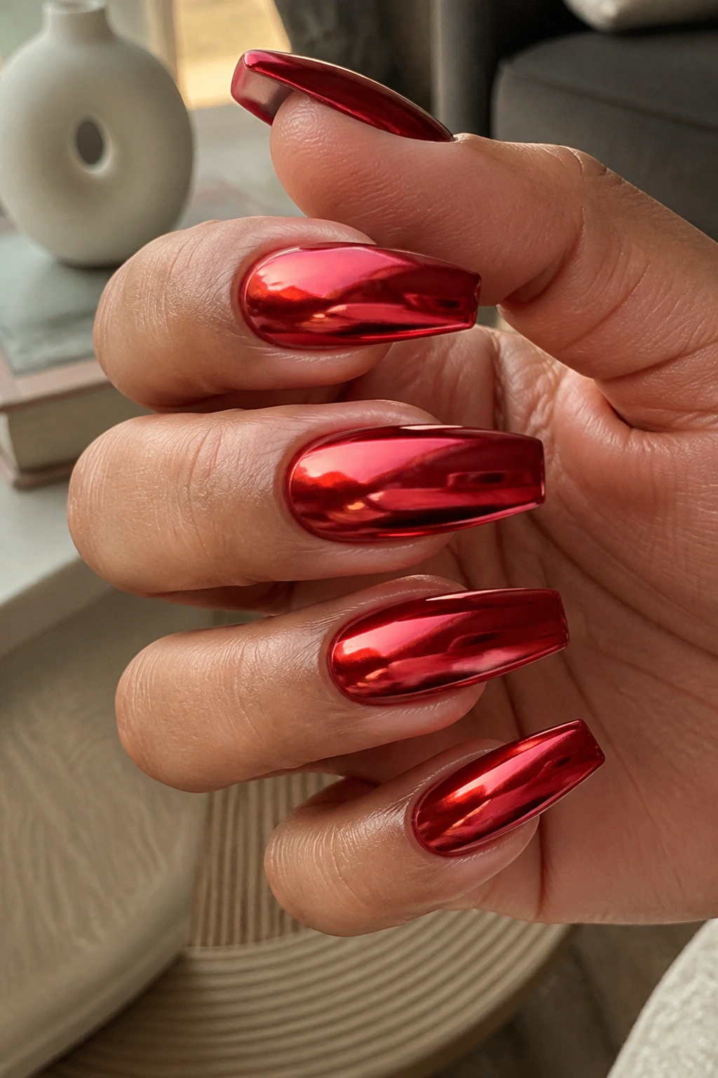 Red chrome coffin nails on a real hand