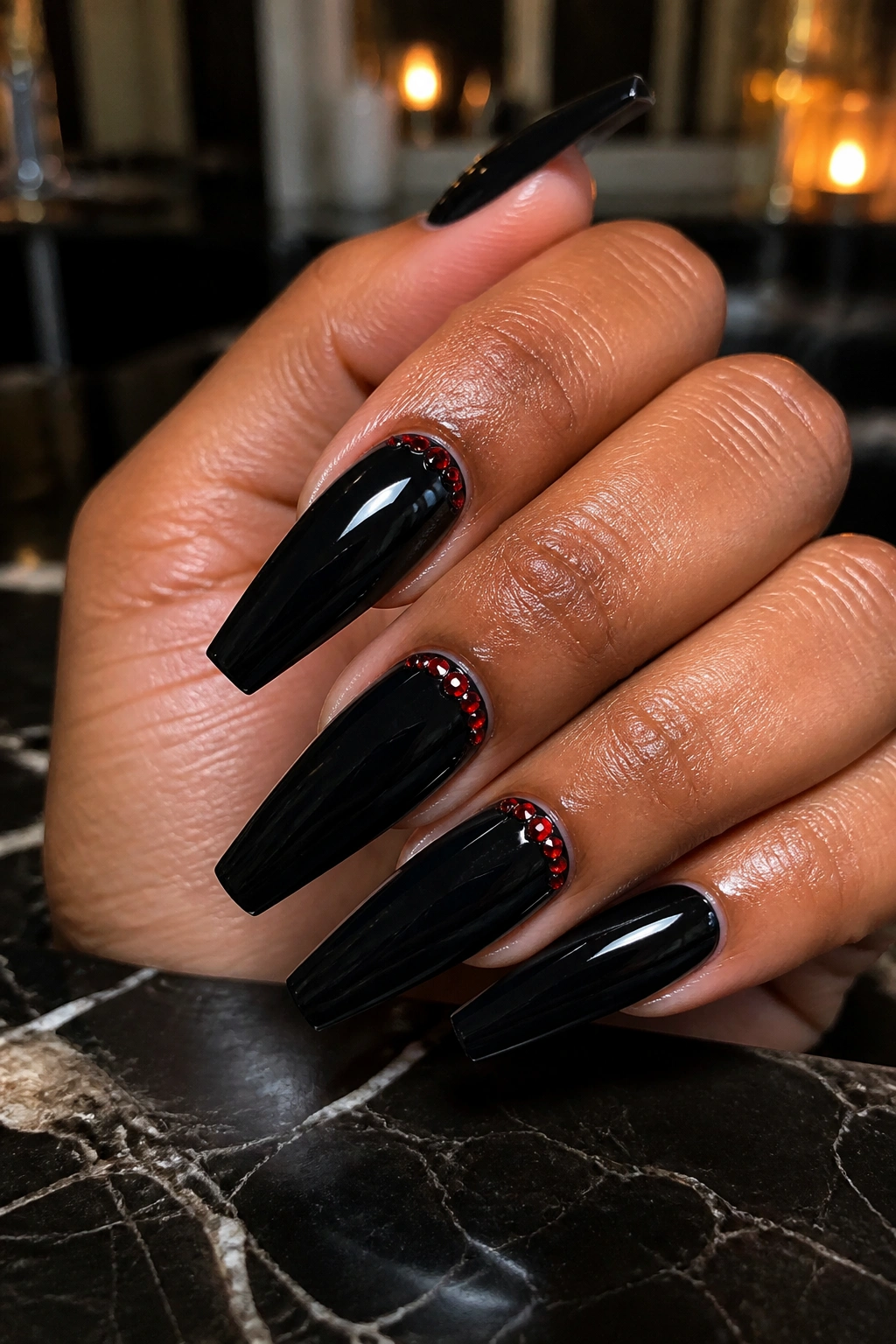 Jet-black coffin nails with red rhinestone cuticle lines on real hand