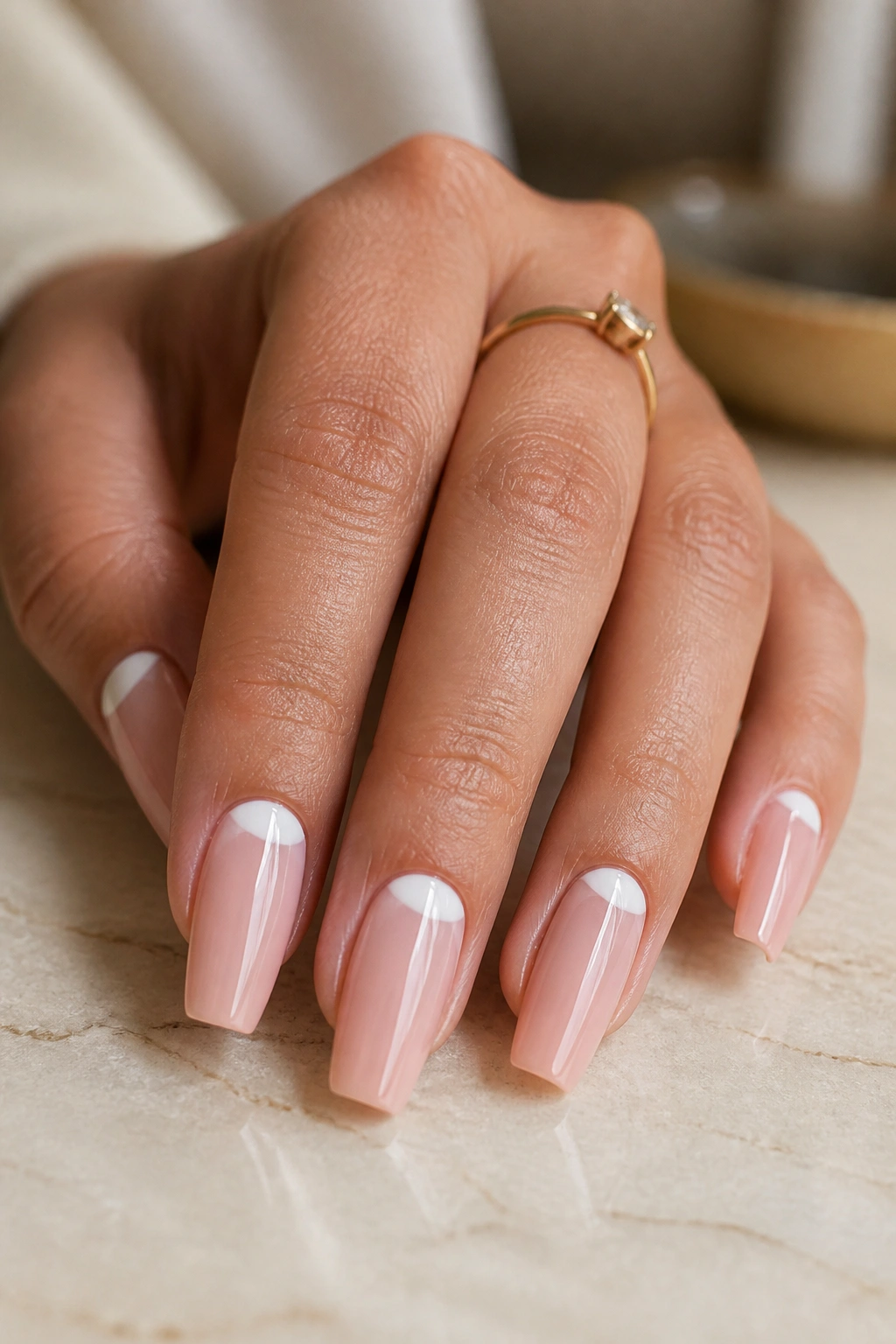 Close-up of coffin nails with a clean cuticle crescent reverse French tip