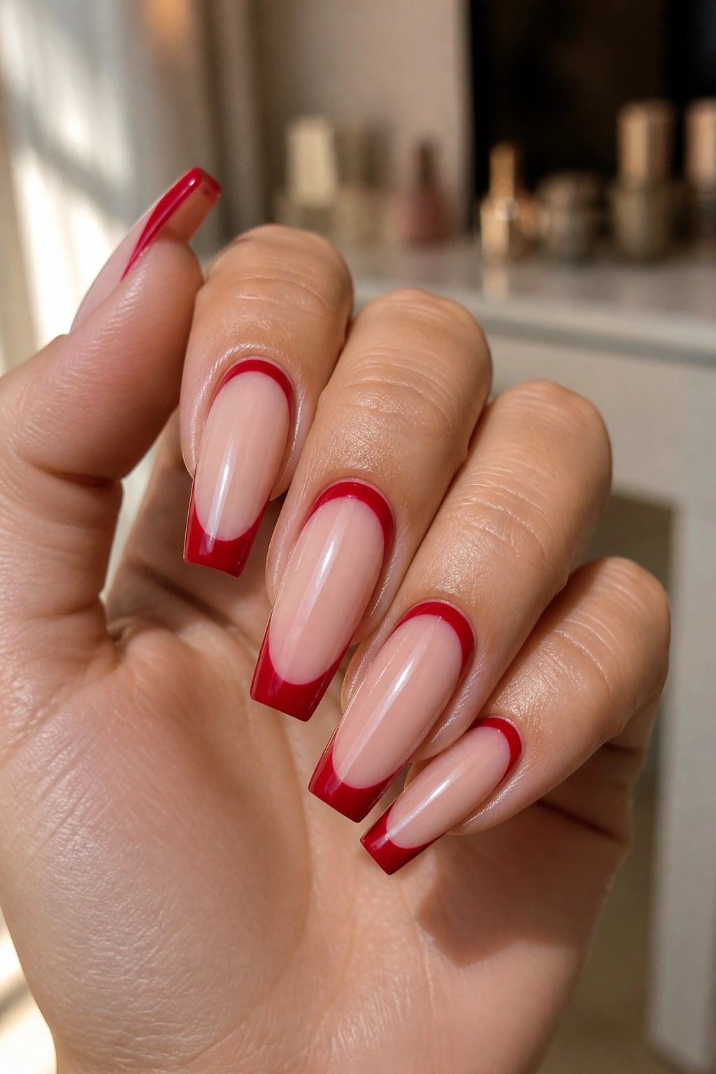 Close-up of reverse red French tips with cuticle framing on a real hand
