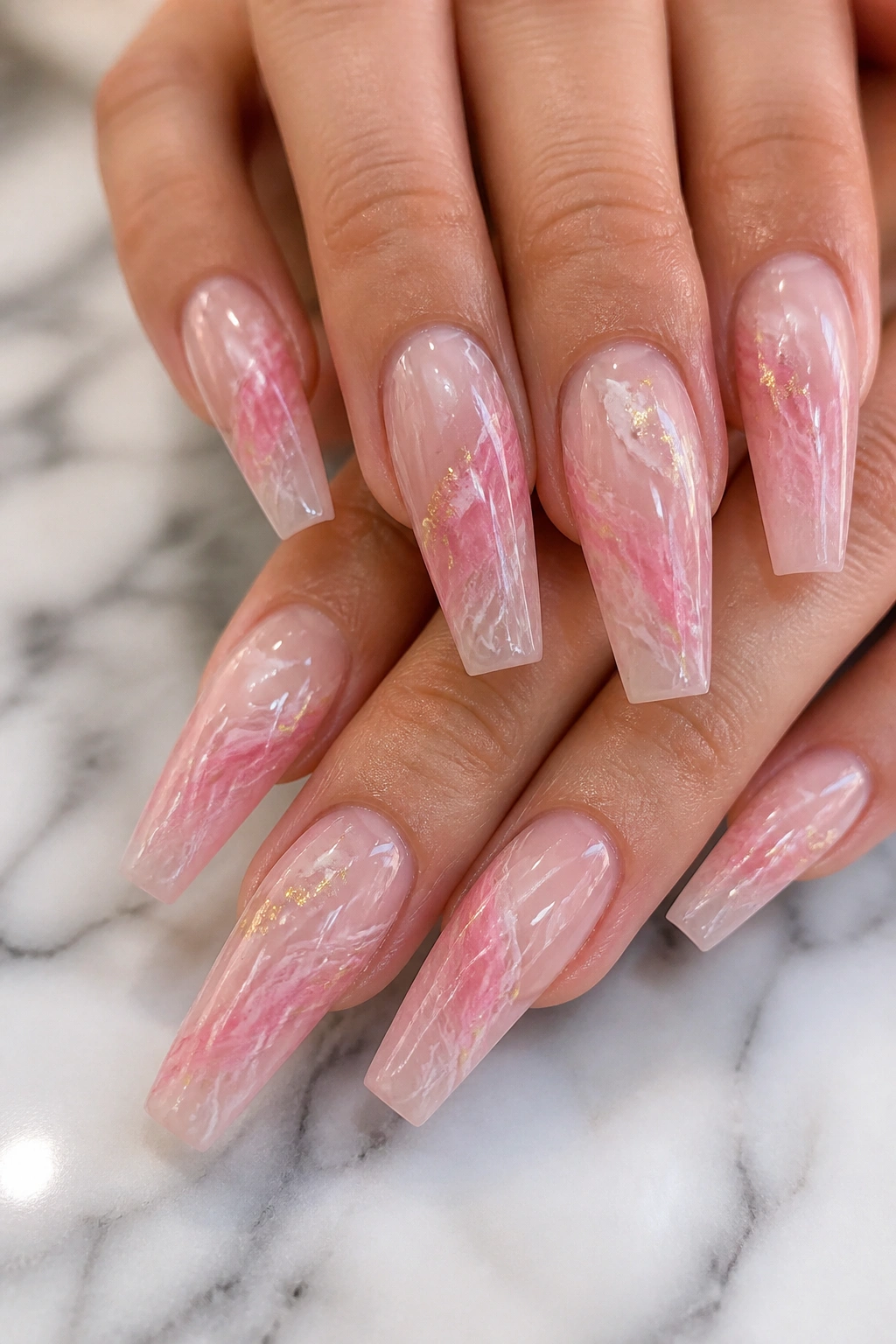Close-up of real hands with rose quartz swirl coffin nails
