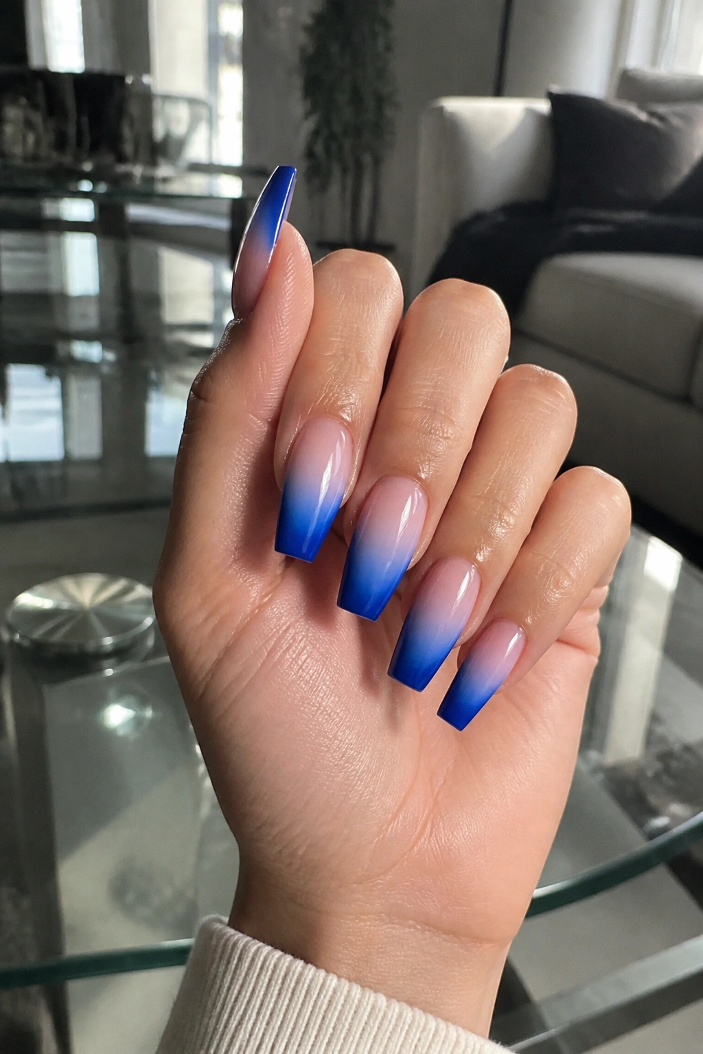 Close-up of royal blue French ombre coffin nails on real hand