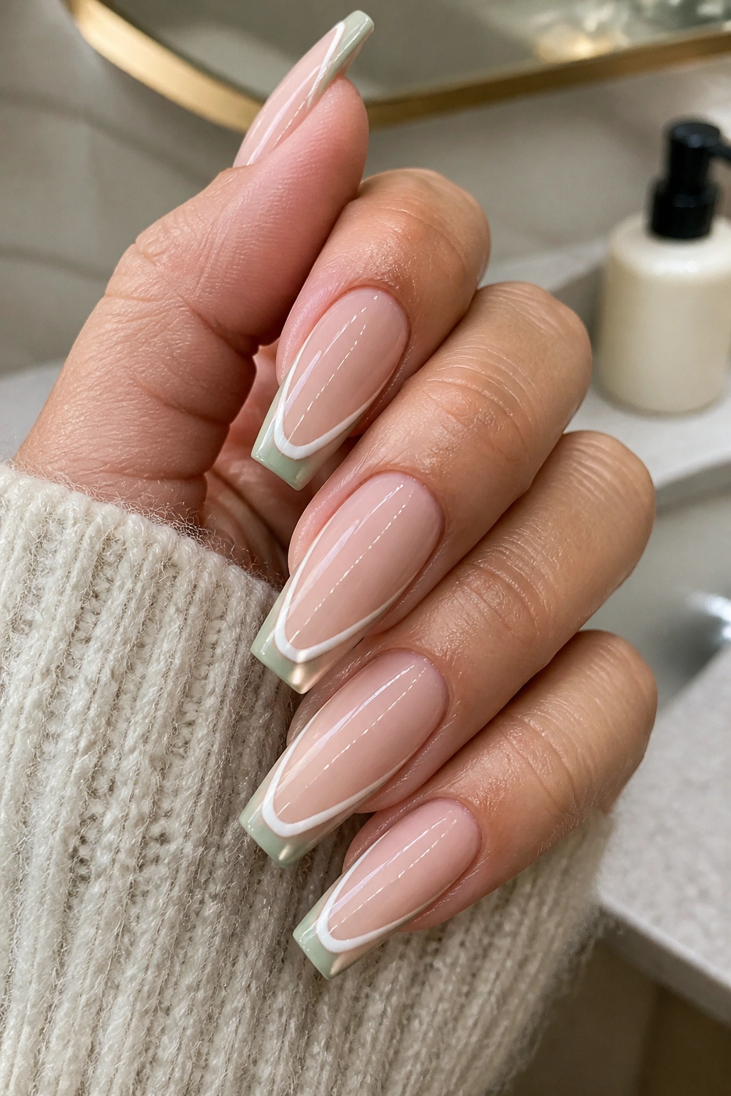 Close-up of hands with Double French Lines in Sage and Cream on coffin nails
