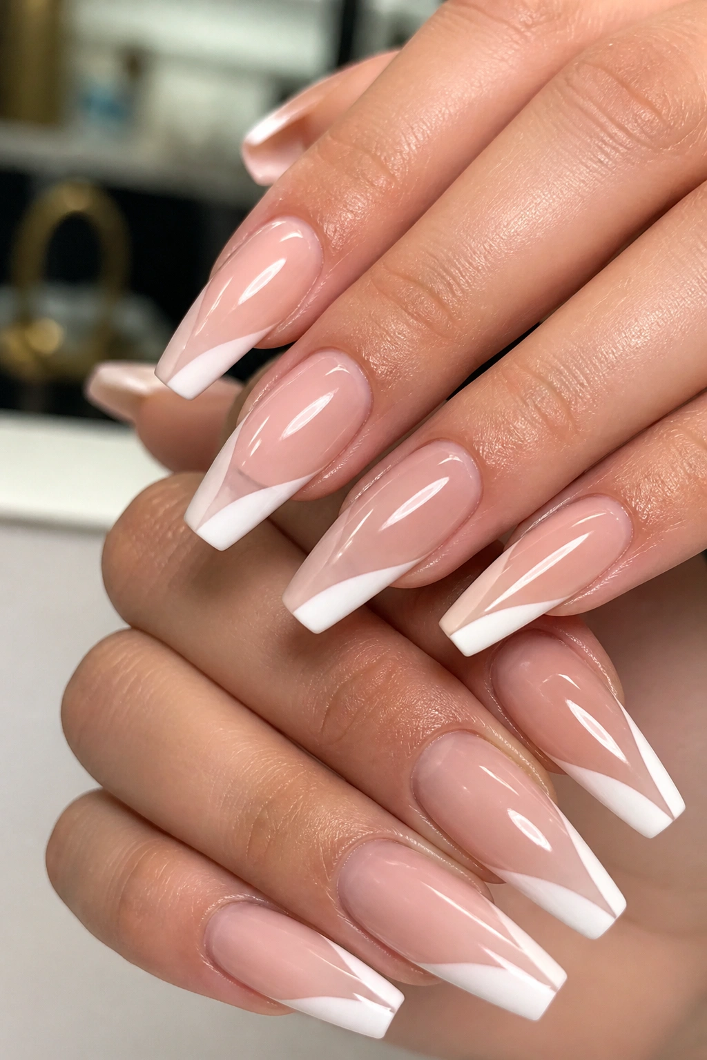 Close-up of hands with Side French Tip Coffin Nails showing angled diagonal tips