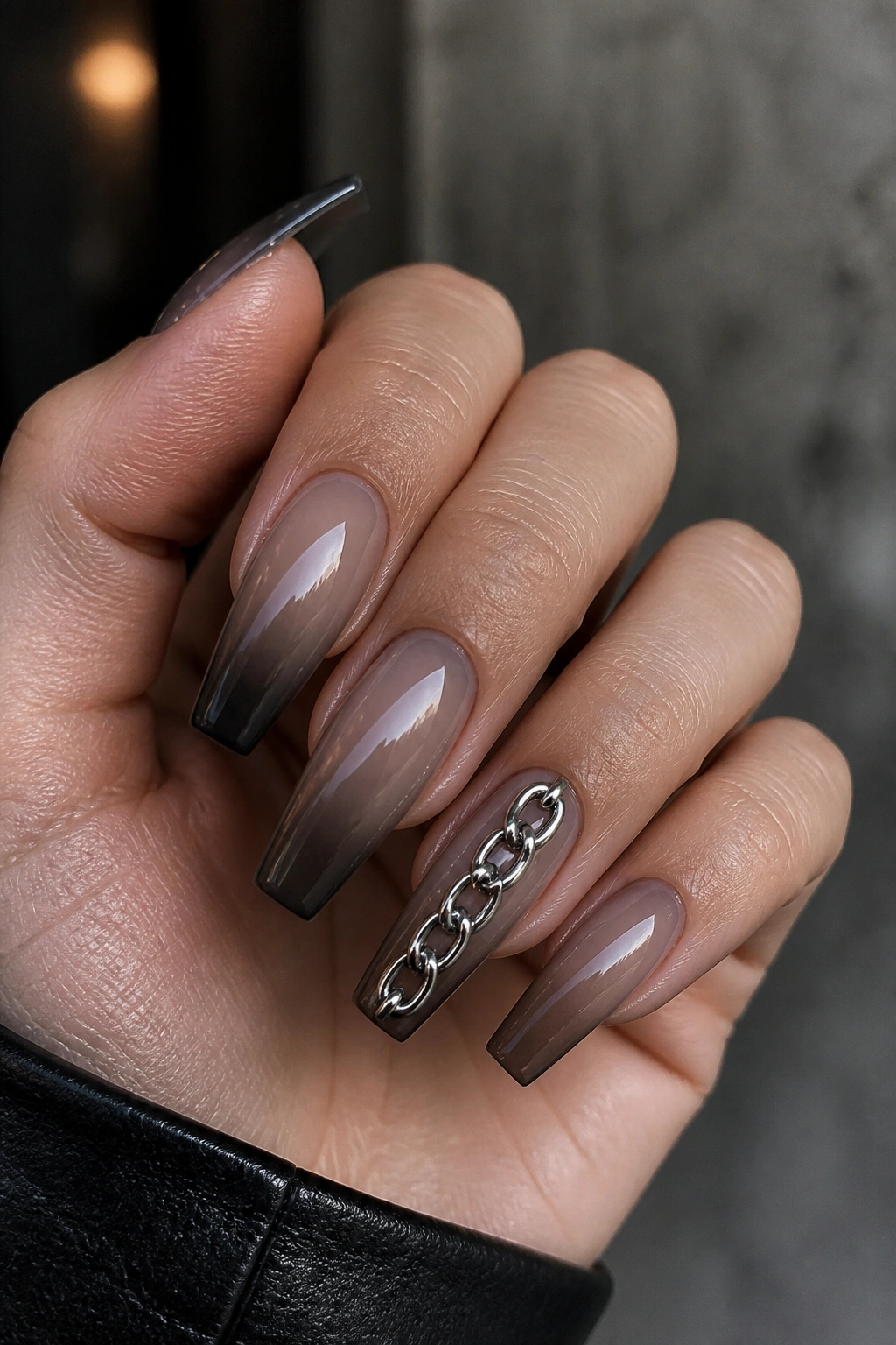 Close-up of silver chain detail on coffin nails