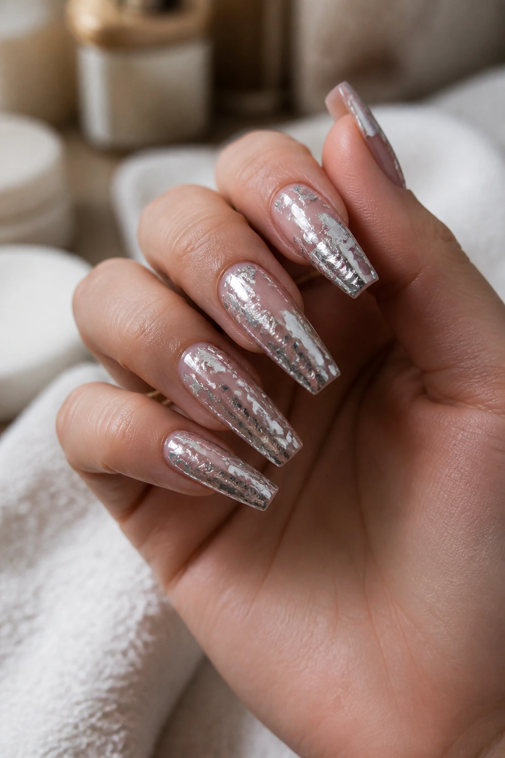 Close-up of molten silver foil nails on a sheer base