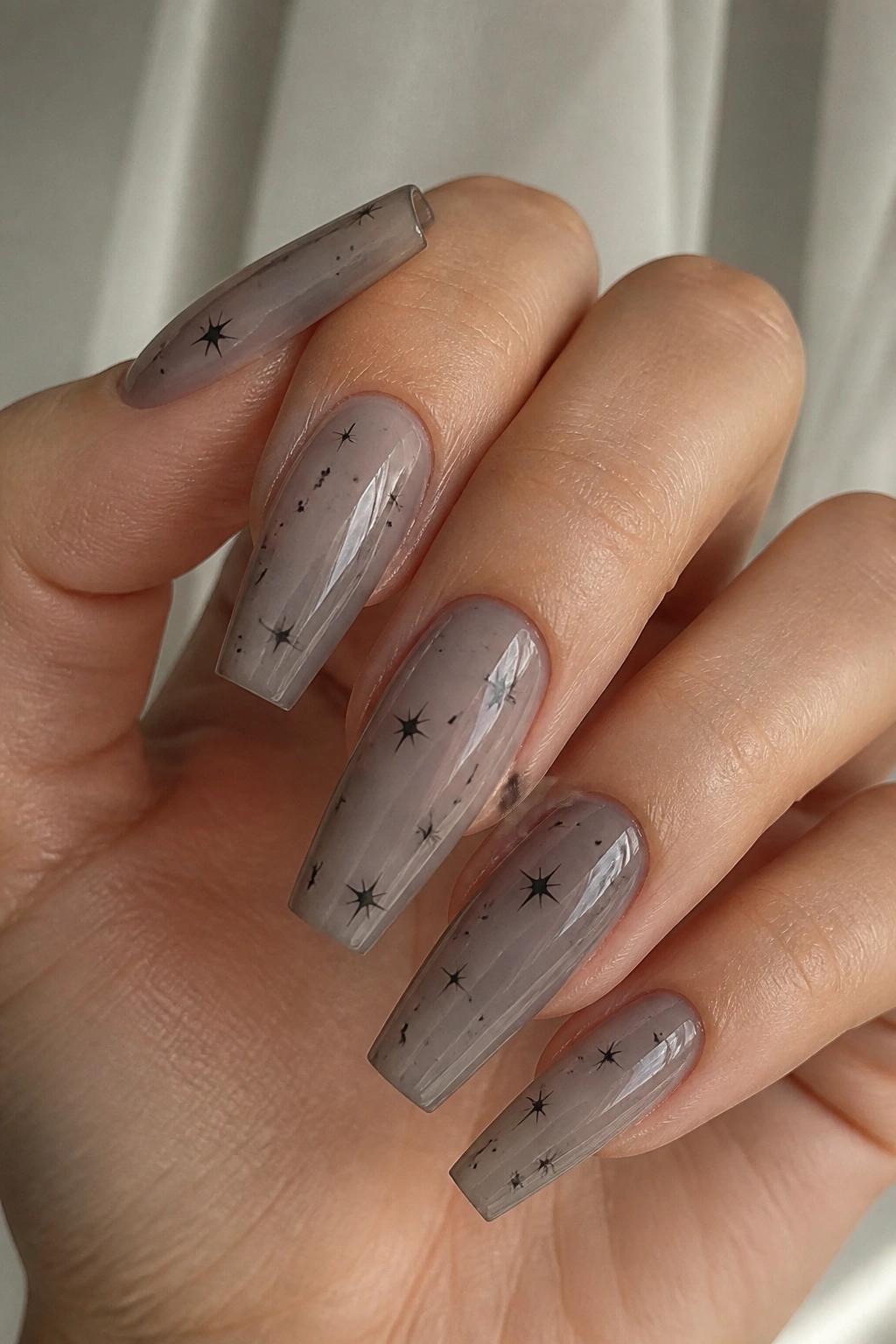 Smoky gray negative space nails with tiny black stars