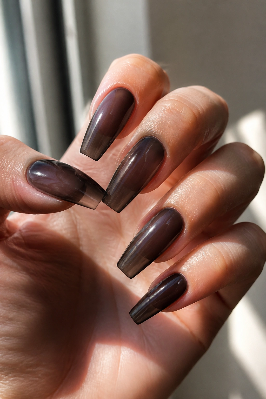 Close-up of soft black jelly coffin nails on a real hand