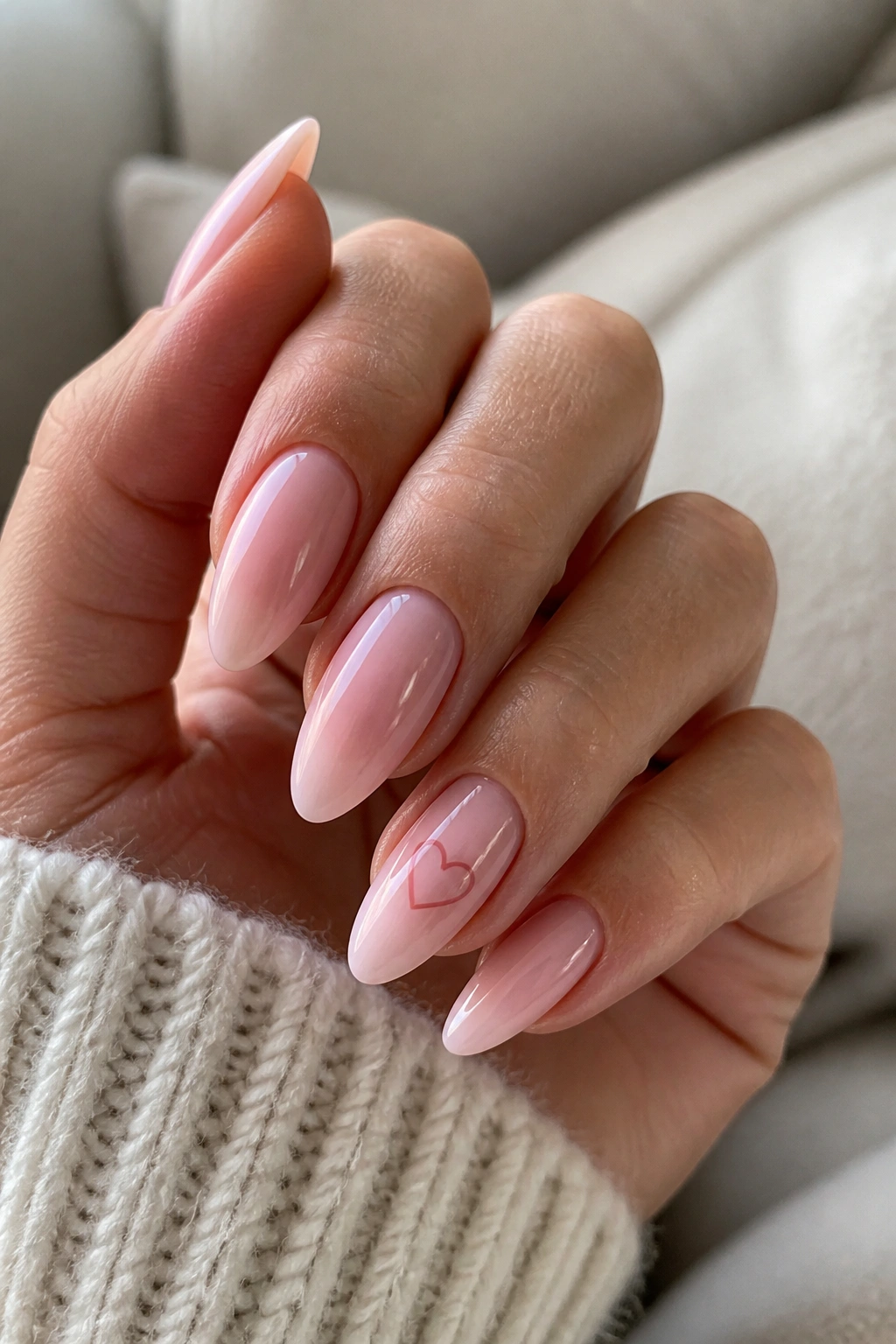 Close-up of almond nails with one sweetheart accent nail