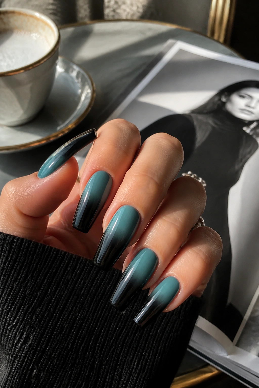 Close-up of teal to black ombre coffin nails on real hand