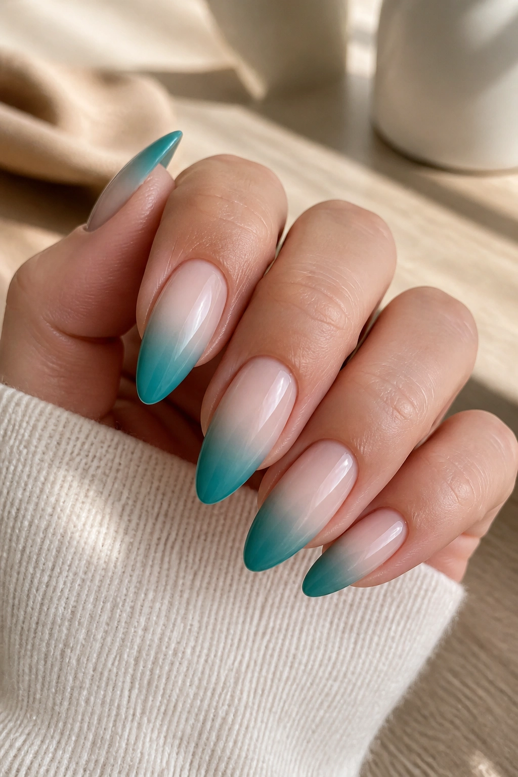 Almond nails teal ombre fading into milky nude