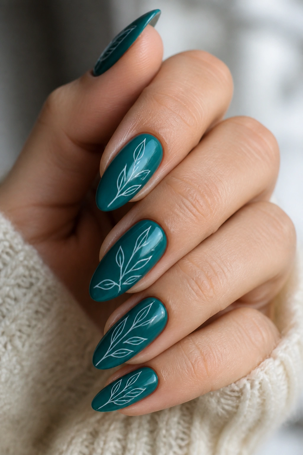 Almond nails with teal base and white botanical line art