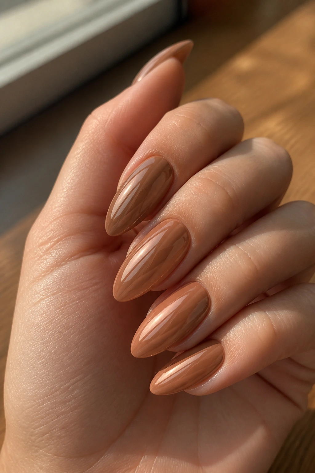 Almond nails in warm toffee nude chrome