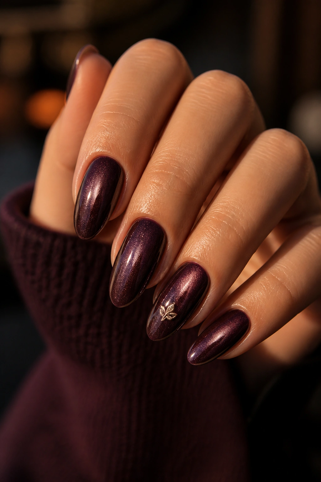 Almond nails with velvet cat-eye base and small monogram motif