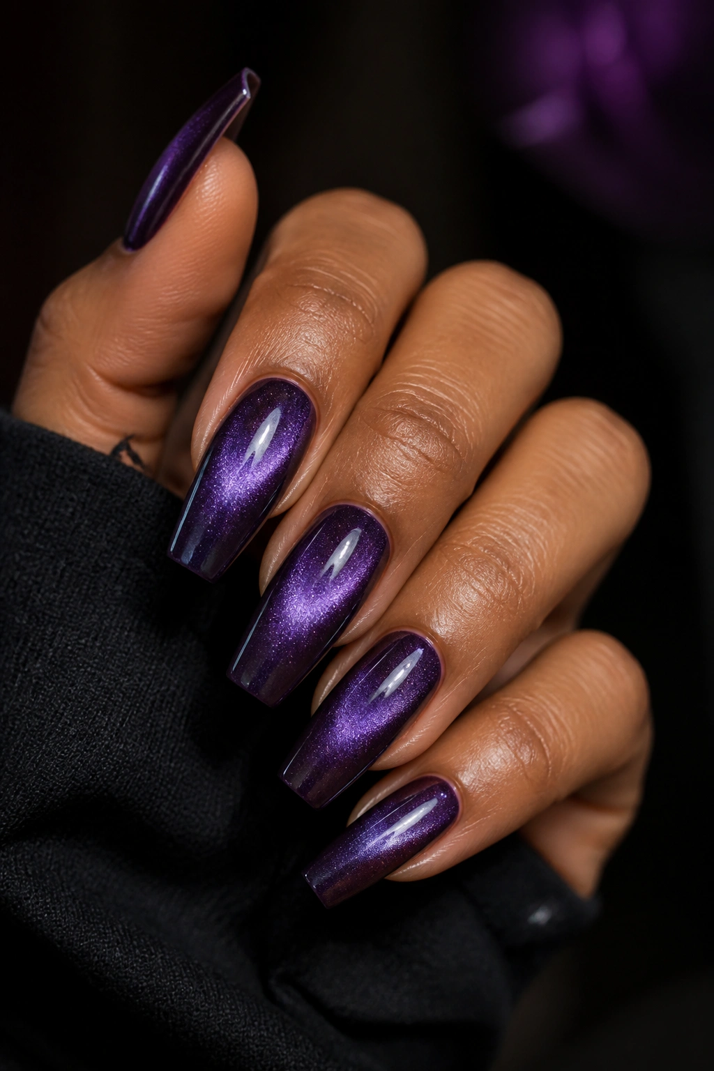 Close-up of velvet magnetic violet coffin nails on a real hand