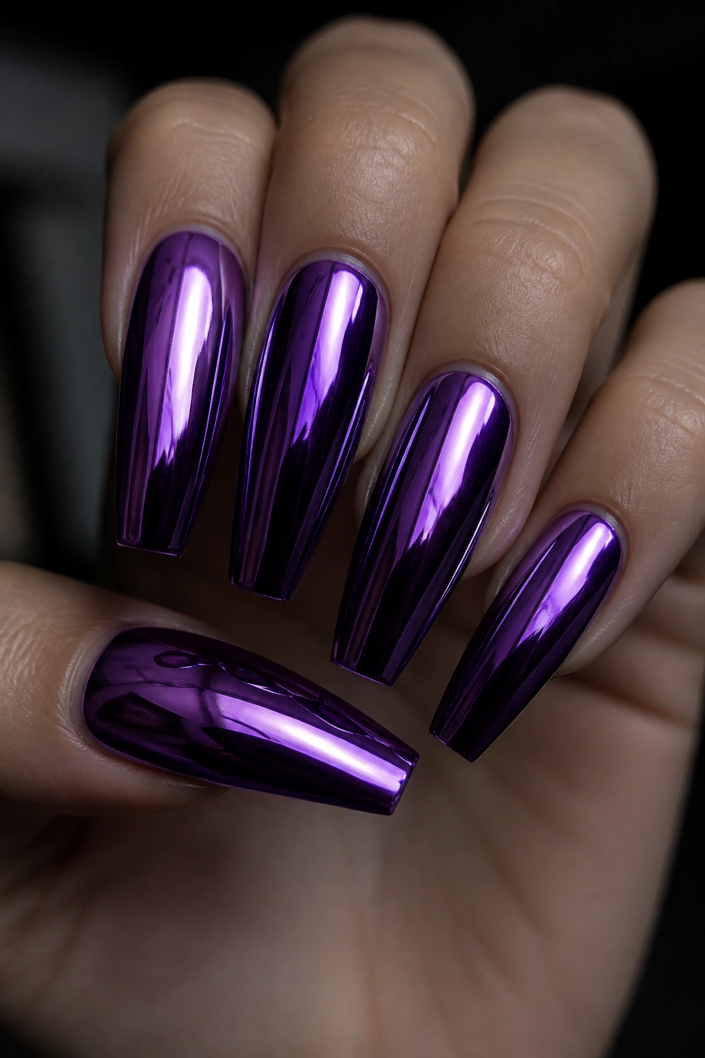 Violet chrome coffin nails close-up on a hand with mirror finish