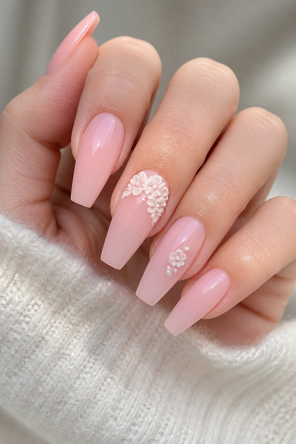Baby pink coffin nails with delicate white 3D flower accents