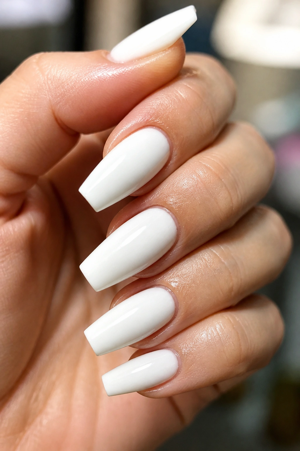 Hand nails with glossy top coat staying bright mid-wear