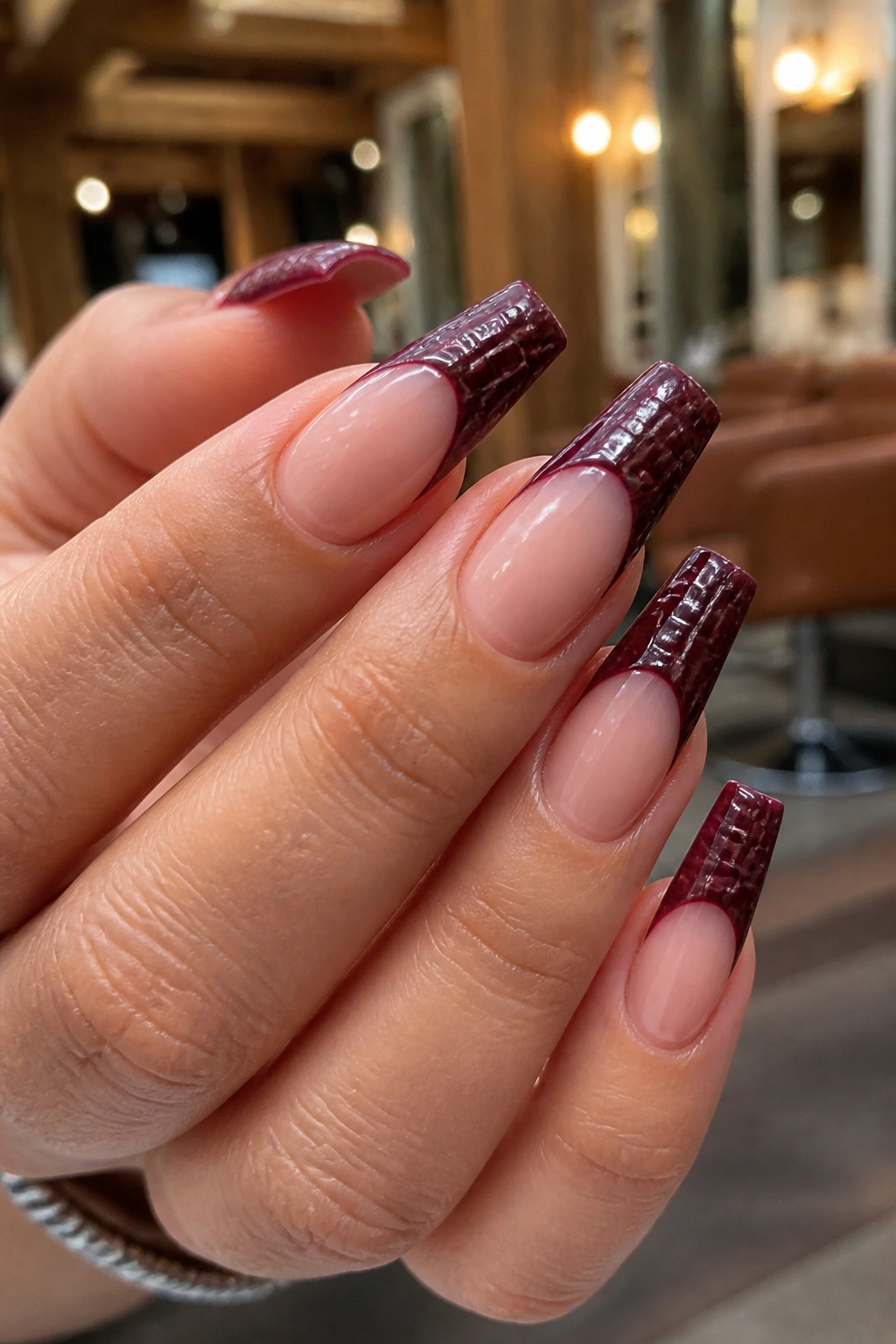 Close-up of coffin nails with wine red croc-texture tips